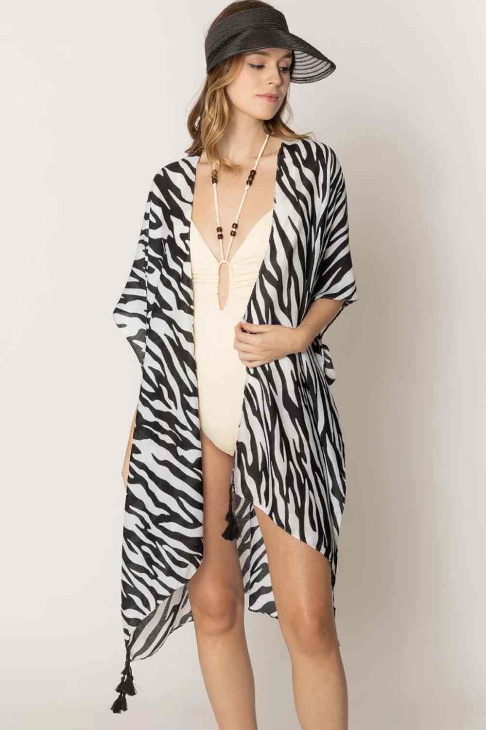 Black Embrace bold style with this striking Zebra Animal Pattern Print Kimono. Crafted from lightweight 100% polyester, this versatile piece features a classic black-and-white zebra print that effortlessly elevates any outfit. The generous 35.4" x 35.4" dimensions provide comfortable coverage and easy layering over dresses, tanks, or casual wear. Perfect for adding an instant fashion statement to your wardrobe, whether you're heading out for brunch or a night out. 