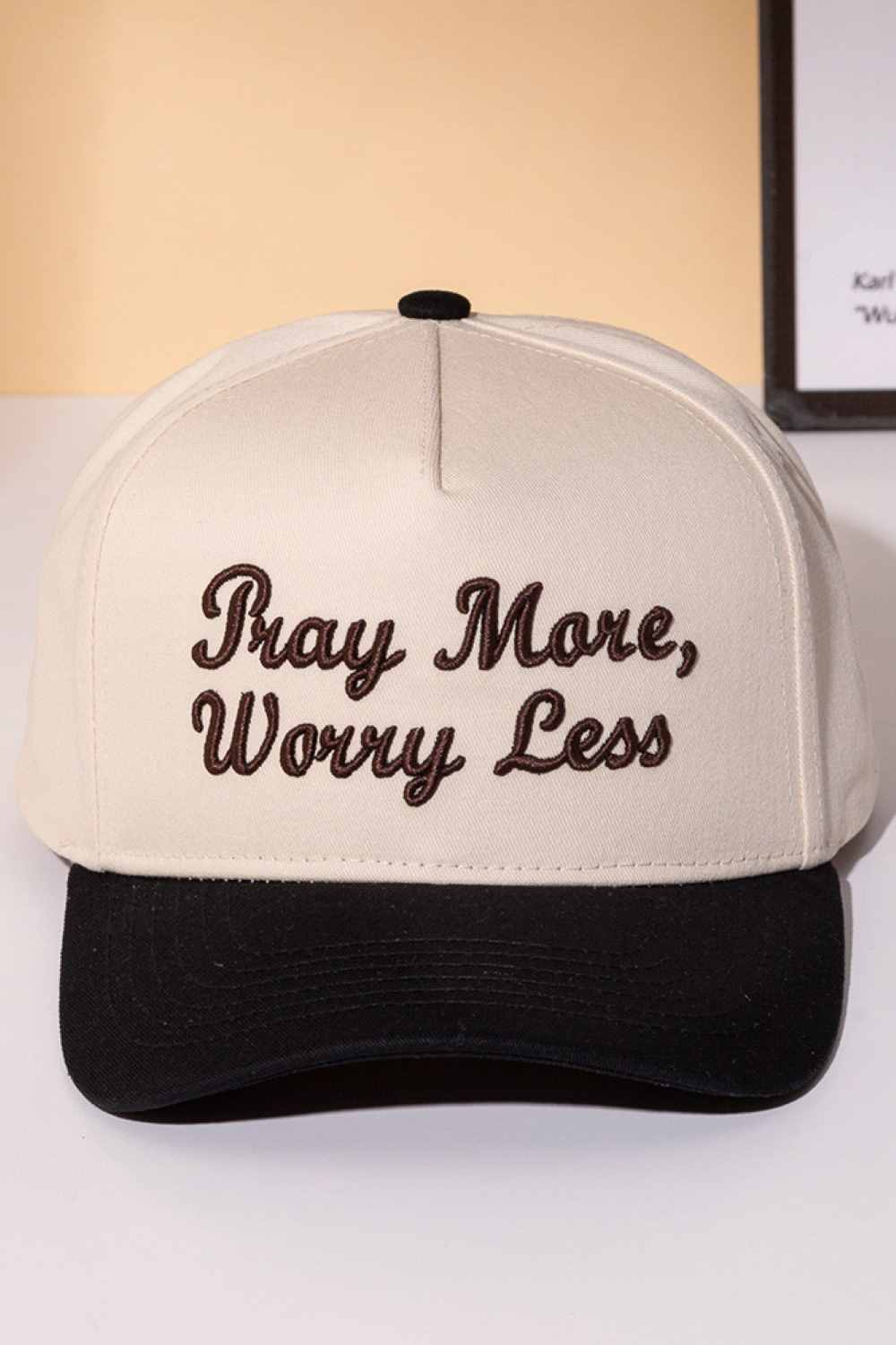 Black Stay grounded with this classic two-tone trucker cap featuring an embroidered "PRAY MORE, WORRY LESS" message. Crafted from 100% cotton for breathability and comfort, it's designed to keep you cool whether you're on the road or relaxing at home. The adjustable snapback ensures a perfect fit for everyone, while the structured six-panel design offers timeless style. A meaningful reminder to embrace peace and let go of stress, one wear at a time.
