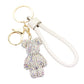 White Bling Bear Figure Faux Leather Strap Bag Charm adds a touch of sparkle and cuteness to your keys or bag. The bling bear figure is encrusted with rhinestones, making it a unique and eye-catching accessory. The faux leather strap adds durability, ensuring you'll have this keychain for years to come. 