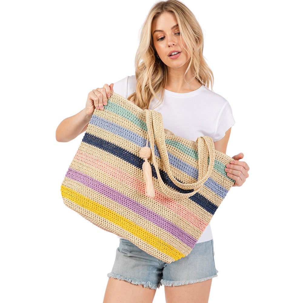 Blue Pom Pom Tassel Multi Color Striped Straw Crochet Tote Bag is a stylish and versatile accessory. Made with durable straw and adorned with playful pom poms and tassels, it adds a touch of fun to any outfit. Perfect for carrying essentials on a day out, it's also a great beach or picnic bag.