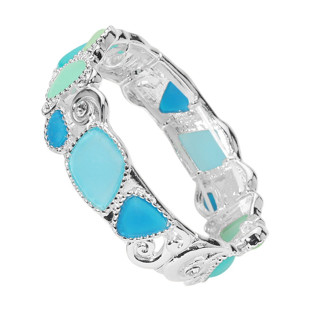 Blue Silver Sea Glass Pebble Stretch Bracelet is expertly crafted with genuine sea glass pebbles for a unique and natural look. The stretch design ensures a comfortable and secure fit. Elevate your style with this one-of-a-kind piece of jewelry.