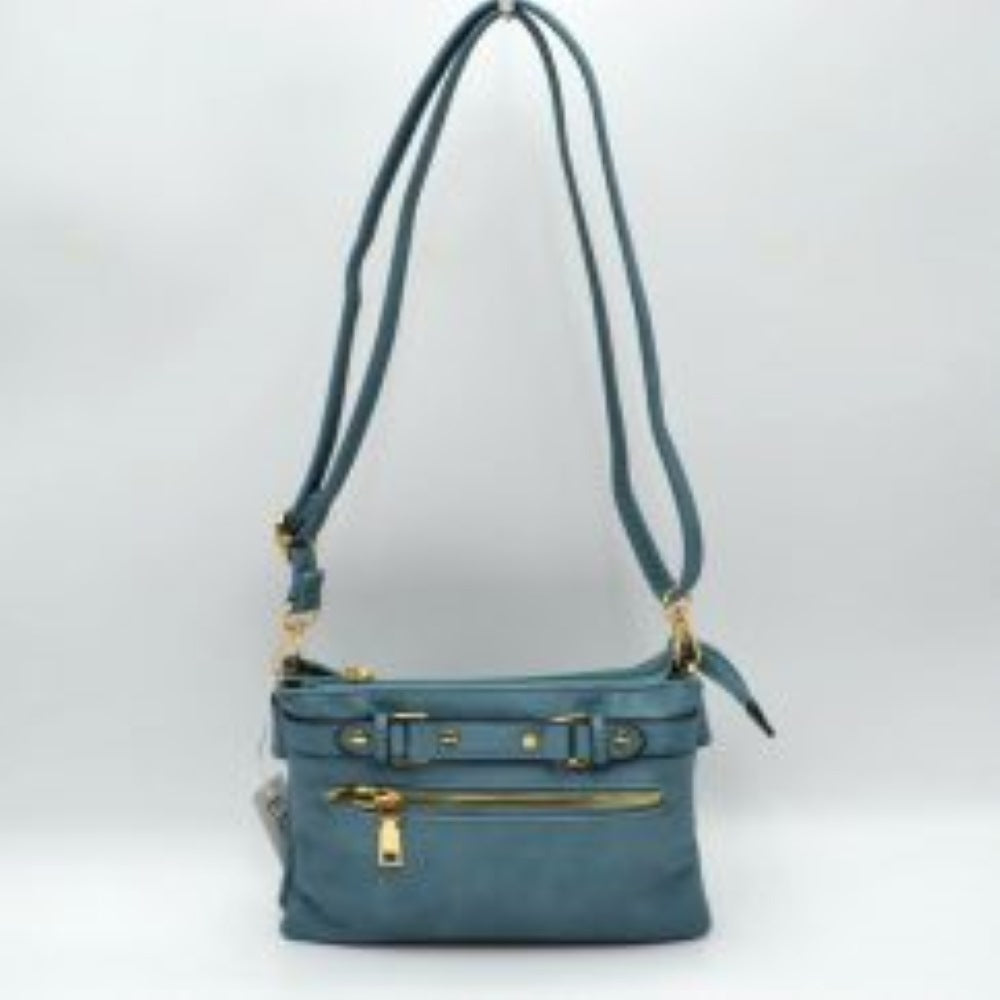 Blue This functional crossbody bag is designed for organized everyday use, featuring a textured exterior equipped with multiple secure storage compartments. The front panel includes a convenient horizontal zippered pocket accented with an oversized metallic zipper pull, situated beneath a decorative horizontal band detailed with metallic studs and loops.