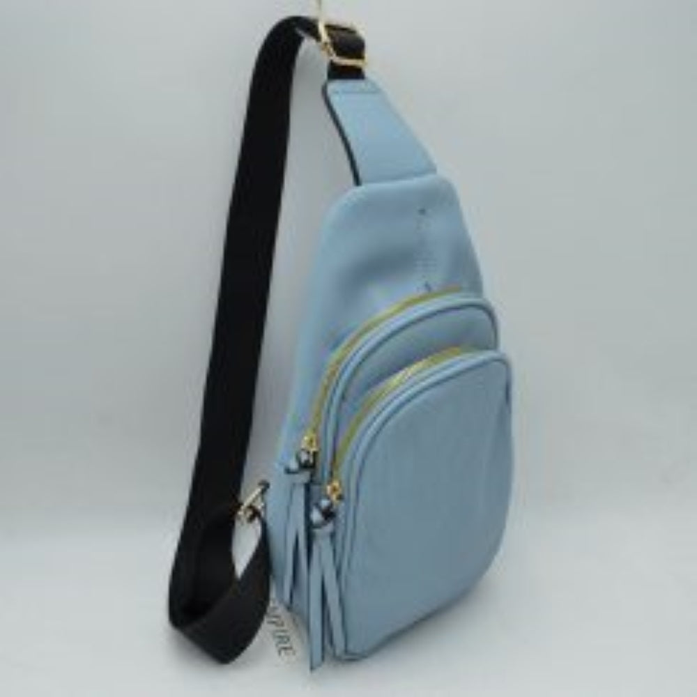 Blue This practical sling bag features a textured, finely ribbed exterior w/ a tapered silhouette designed for comfortable everyday use. It offers organized storage compartments, including a curved main zippered section and a matching smaller front zippered pouch, both enhanced by elongated vertical tassel pulls hanging from the sliders. The bag is equipped w/ a single wide fabric shoulder strap attached to a smooth top panel & secured w/ a metallic adjustment buckle to easily customize the carrying length.
