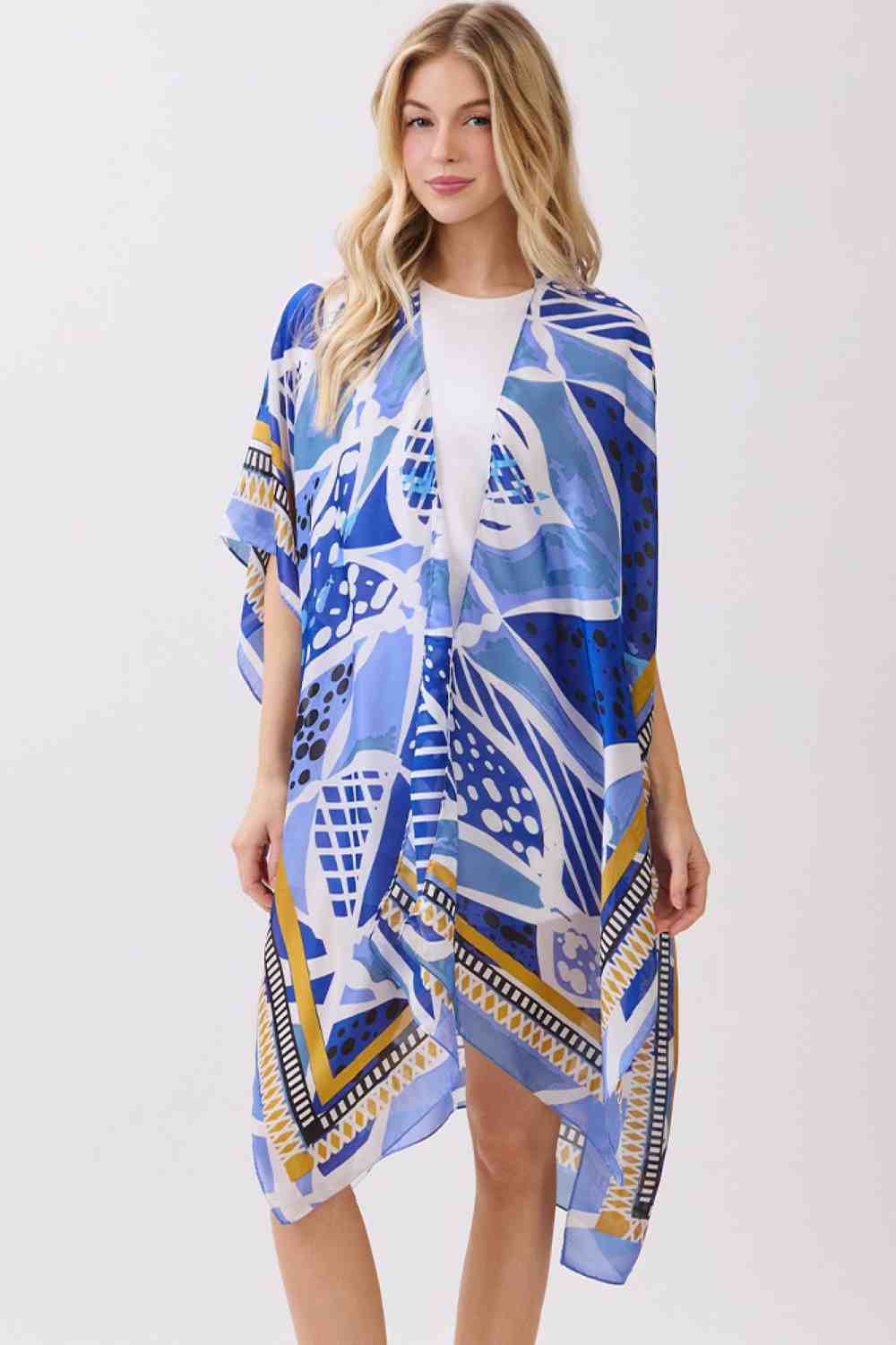 Blue Effortless elegance meets comfort in this abstract botanical kimono cover-up. Featuring a striking botanical print with decorative pattern edges, this lightweight piece drapes beautifully over any outfit. The silky polyester fabric feels luxurious against skin while maintaining easy care. Perfect for layering at the beach, poolside, or casual outings. Dimensions: 35" x 36". 100% polyester. Made in China.