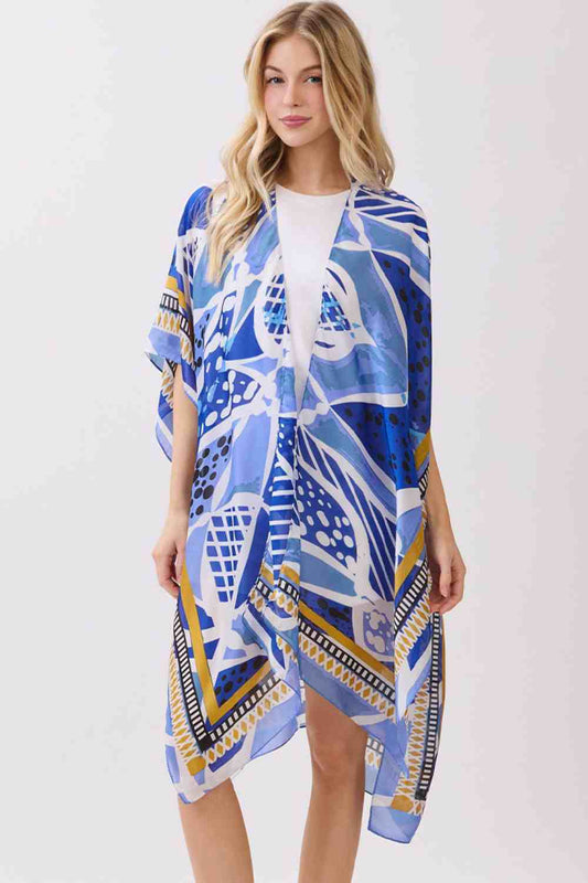 Blue Effortless elegance meets comfort in this abstract botanical kimono cover-up. Featuring a striking botanical print with decorative pattern edges, this lightweight piece drapes beautifully over any outfit. The silky polyester fabric feels luxurious against skin while maintaining easy care. Perfect for layering at the beach, poolside, or casual outings. Dimensions: 35" x 36". 100% polyester. Made in China.