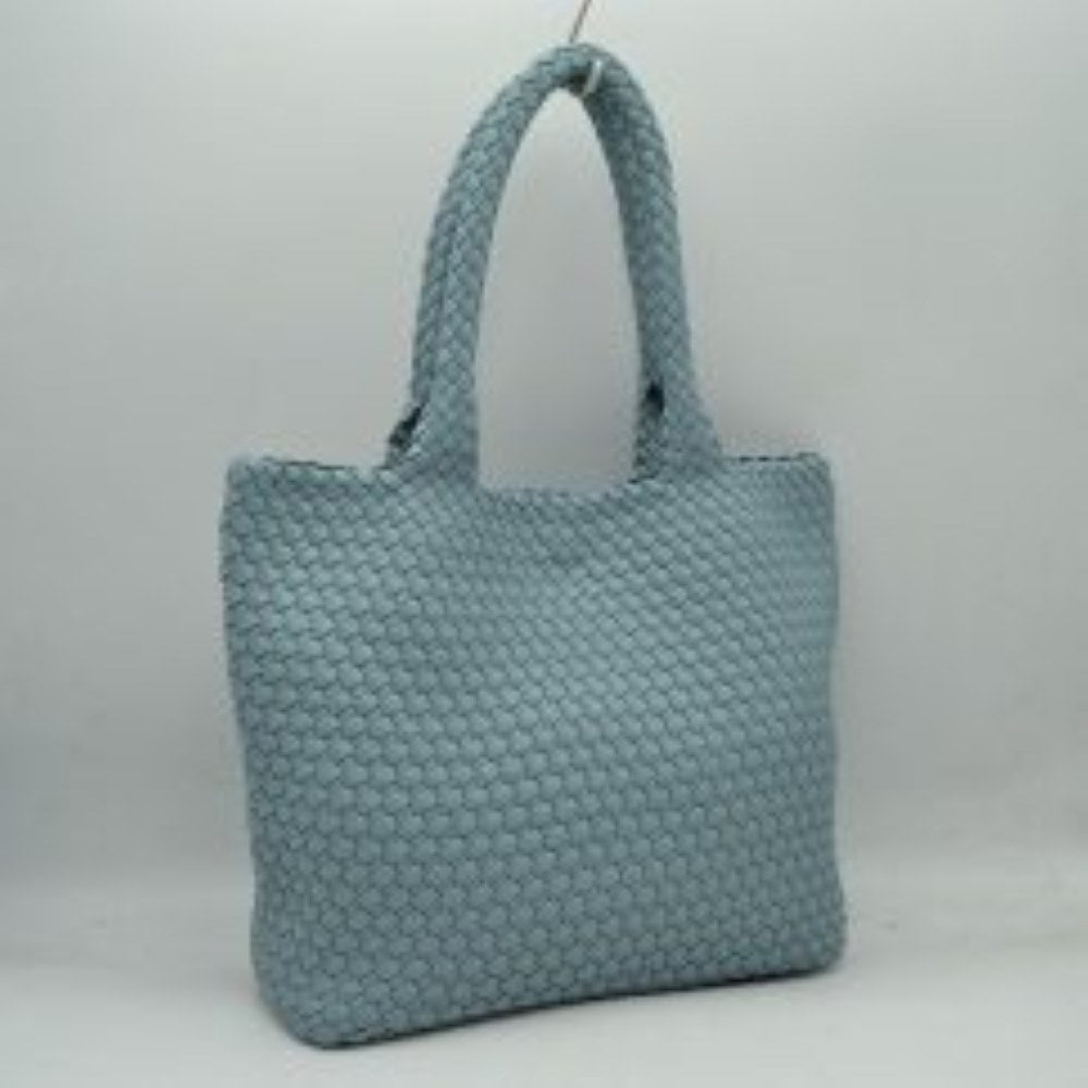 Blue This structured tote bag features an intricate basket-weave design across its body and integrated shoulder straps, creating a textured look suitable for everyday use. The main storage compartment offers a wide, open-top design for easy access to daily essentials. Accompanying the larger bag is a matching smaller pouch with a distinct woven exterior pattern and a secure gold-tone top zipper closure to keep smaller items organized.