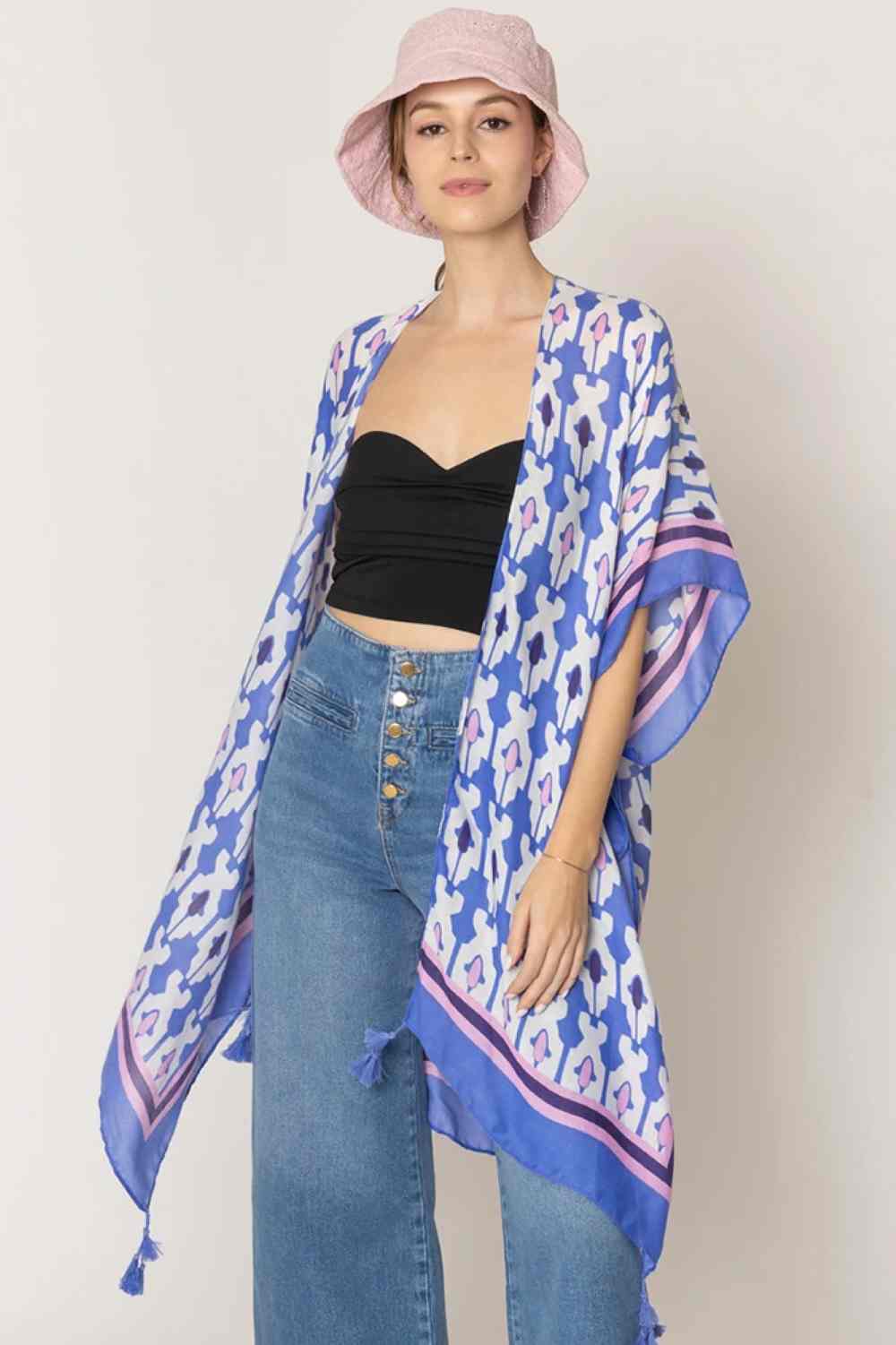 Blue Effortless elegance meets bohemian charm with this stunning tile print kimono. Crafted from lightweight 100% polyester, this versatile piece features a captivating geometric tile pattern with contrasting stripe detailing along the edges and playful tassels for added movement and flair. Perfect for layering over any outfit, this kimono drapes beautifully at 35.4" x 35.4", making it ideal for beach days, casual outings, or relaxed evenings. 