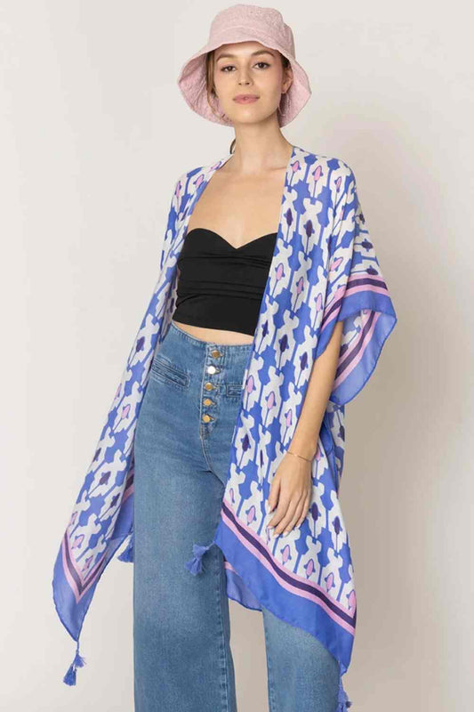Blue Effortless elegance meets bohemian charm with this stunning tile print kimono. Crafted from lightweight 100% polyester, this versatile piece features a captivating geometric tile pattern with contrasting stripe detailing along the edges and playful tassels for added movement and flair. Perfect for layering over any outfit, this kimono drapes beautifully at 35.4" x 35.4", making it ideal for beach days, casual outings, or relaxed evenings. 
