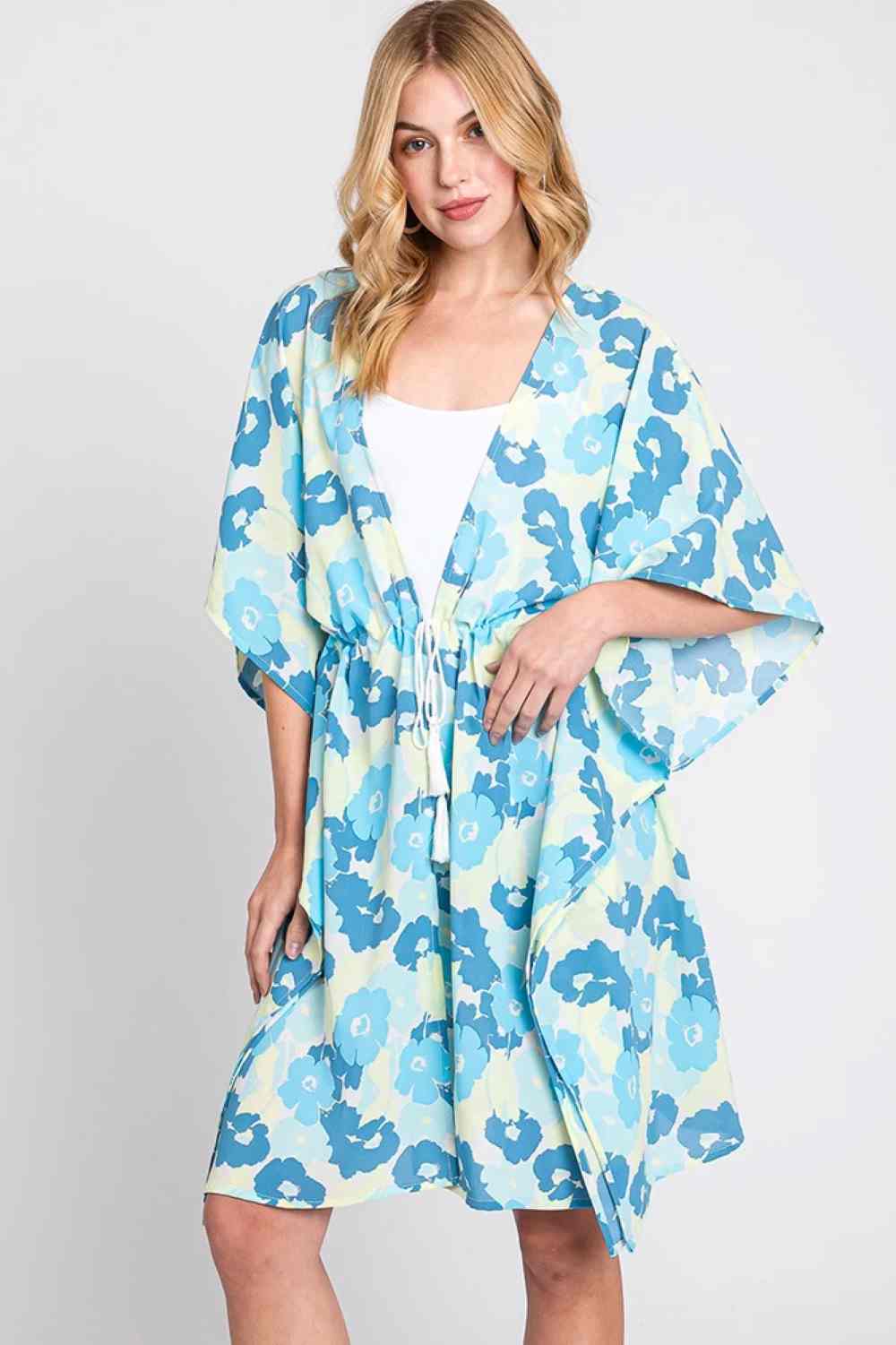 Blue Effortless beach style meets playful charm with this Daisy Tie Drawstring Open Front Cover Up. Crafted from lightweight 100% polyester, this versatile piece features an open front design with adjustable tie drawstring closure for a customizable fit. Perfect for layering over swimwear or casual outfits, the relaxed silhouette offers comfort and coverage. Measuring 39" x 35", it's an ideal companion for poolside lounging, beach days, or resort wear.