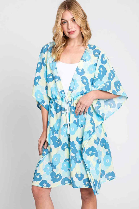 Blue Effortless beach style meets playful charm with this Daisy Tie Drawstring Open Front Cover Up. Crafted from lightweight 100% polyester, this versatile piece features an open front design with adjustable tie drawstring closure for a customizable fit. Perfect for layering over swimwear or casual outfits, the relaxed silhouette offers comfort and coverage. Measuring 39" x 35", it's an ideal companion for poolside lounging, beach days, or resort wear.