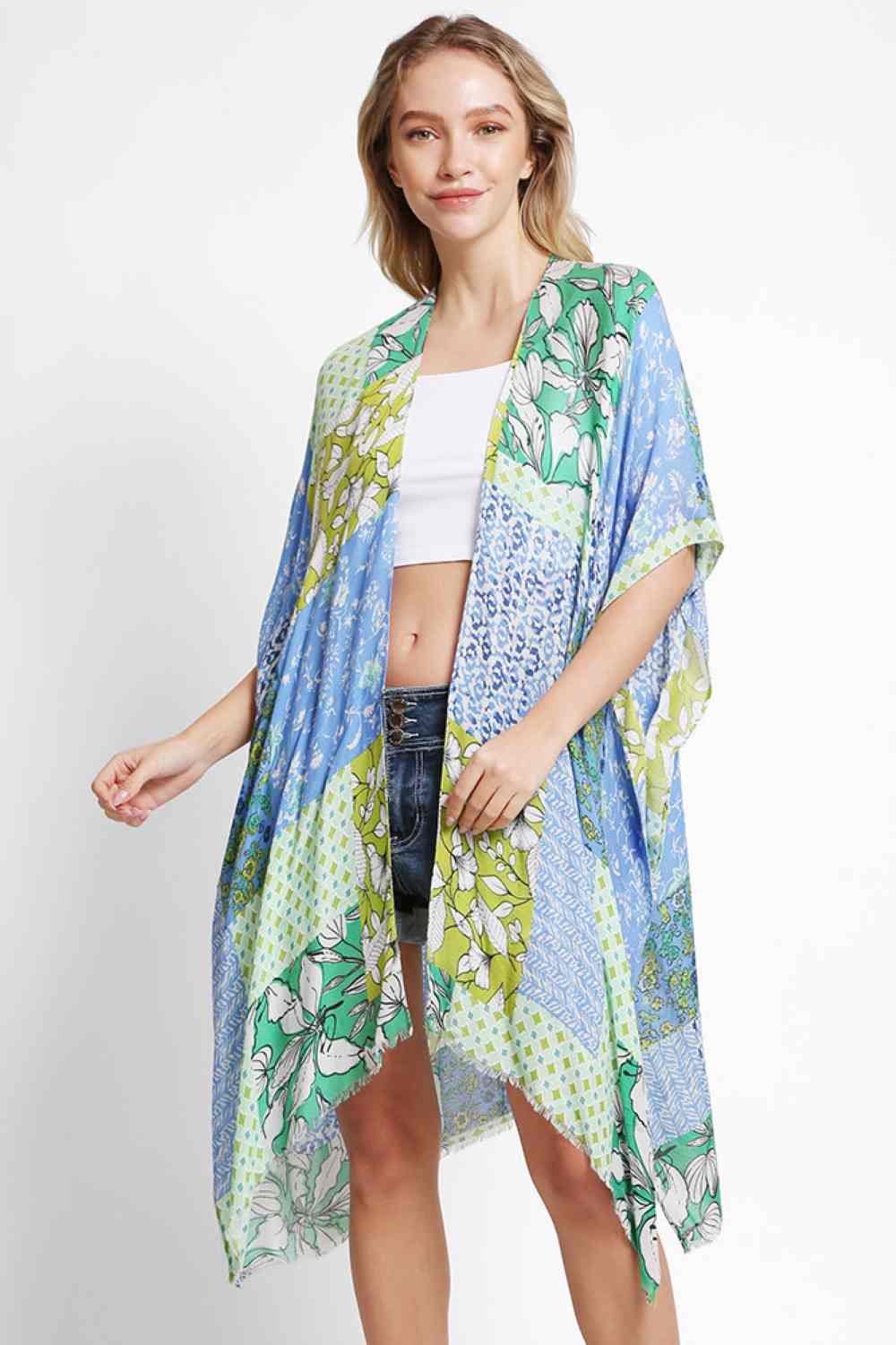 Blue Effortless summer style meets comfort in this floral mixed pattern kimono cover up. Crafted from 100% viscose, the lightweight fabric drapes beautifully while keeping you cool and comfortable. The versatile one-size fit works for various body types, making it perfect for beach days, poolside lounging, or casual outings. Layer it over your favorite swimsuit or dress for an instantly polished look. Ideal for warm weather adventures.