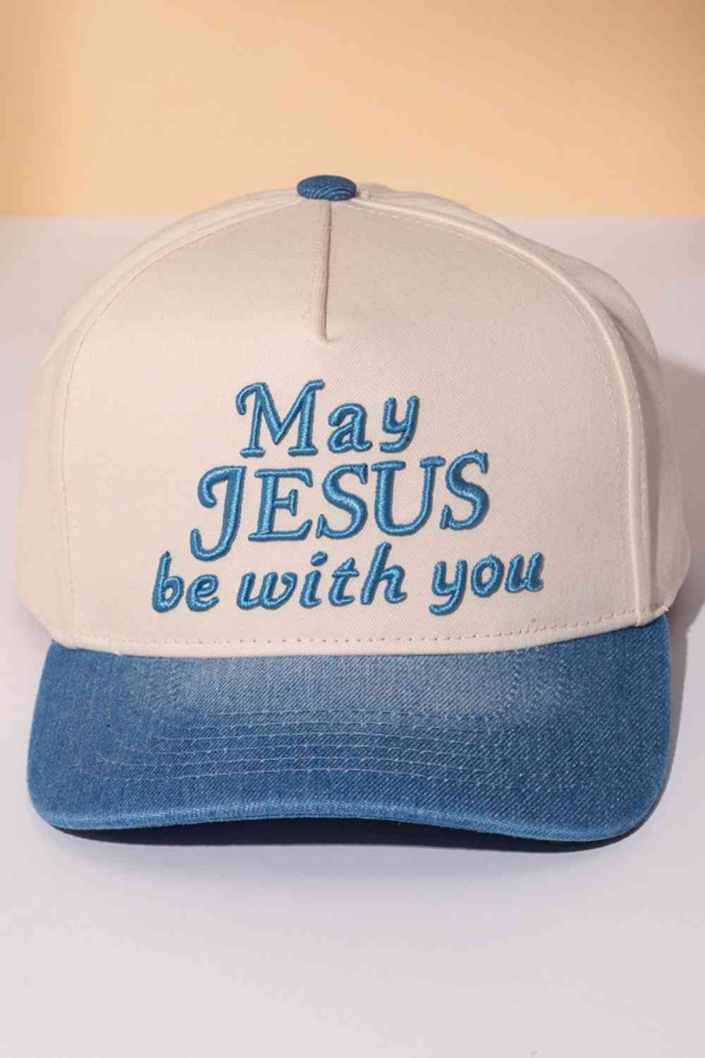 Blue Classic two-tone trucker cap featuring an embroidered "MAY JESUS BE WITH YOU" message across the front. Crafted from 100% cotton for breathability and comfort, this snapback design offers one-size-fits-most versatility. Perfect for everyday wear, outdoor activities, or expressing your faith. The structured six-panel construction and mesh back panels provide durability and ventilation. An ideal accessory for those seeking meaningful style with spiritual significance.