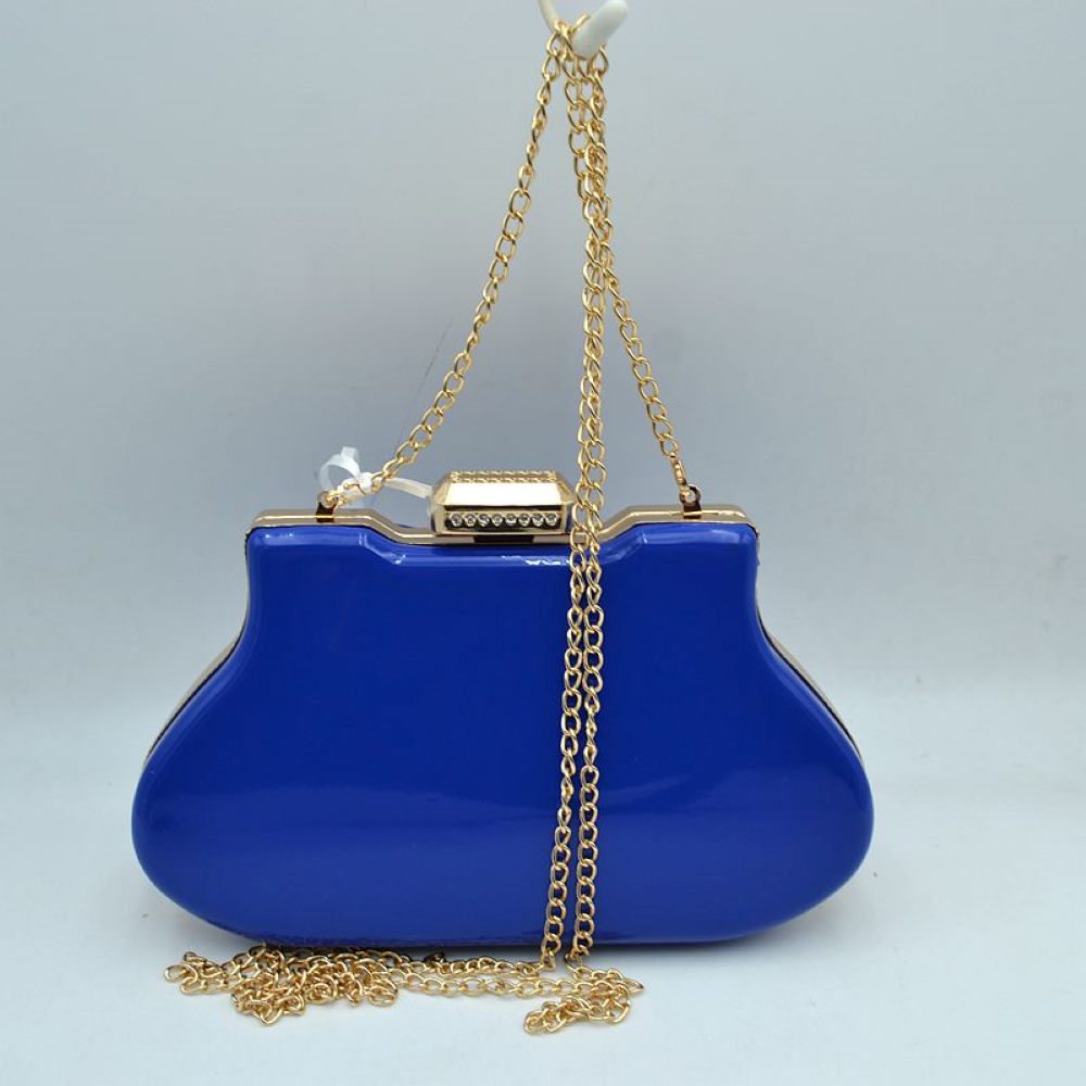 Blue This elegant evening clutch bag features a vibrant glossy hard-shell finish and a structured, curved silhouette, making it a sophisticated addition to any special occasion. The secure top frame is fastened with a striking rectangular gold-tone clasp adorned with sparkling rhinestones. Equipped with a delicate, detachable metallic chain-link shoulder strap, this sleek accessory offers a classic look and convenient hands-free styling options.