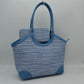 Blue Infuse your daily routine with classic sophistication with this elegant two-piece handbag set, featuring a spacious shoulder tote and a matching zip-around wristlet wallet. The tote showcases a beautiful multi-tonal woven tweed pattern, sharply contrasted by clean, structured top borders and reinforced base corners that preserve its graceful shape. Designed with extra-long, arched shoulder straps that slip comfortably over your arm