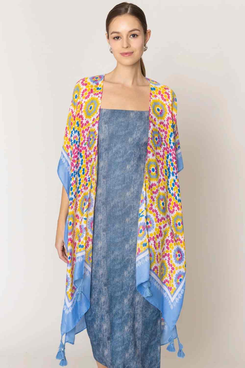 Blue Effortless elegance meets bohemian charm with this stunning tile print kimono. Crafted from lightweight 100% polyester, this versatile piece features a captivating geometric tile pattern with contrasting stripe detailing along the edges and playful tassels for added movement and flair. Perfect for layering over any outfit, this kimono drapes beautifully at 35.4" x 35.4", making it ideal for beach days, casual outings, or relaxed evenings.