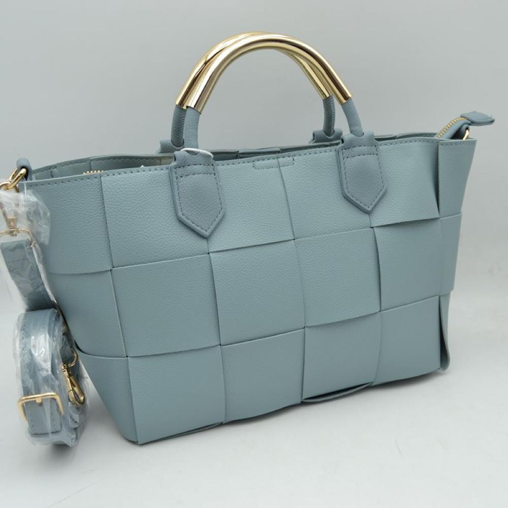 Blue Make a sophisticated statement with this beautifully designed satchel handbag. The exterior showcases an eye-catching, extra-wide basket-weave pattern that adds modern texture and dimensional depth to a classic silhouette. Setting this piece apart is the sleek, polished metallic accent arched over the top carry handles, bringing an upscale, architectural touch to your look. Equipped with soft, flexible side panels
