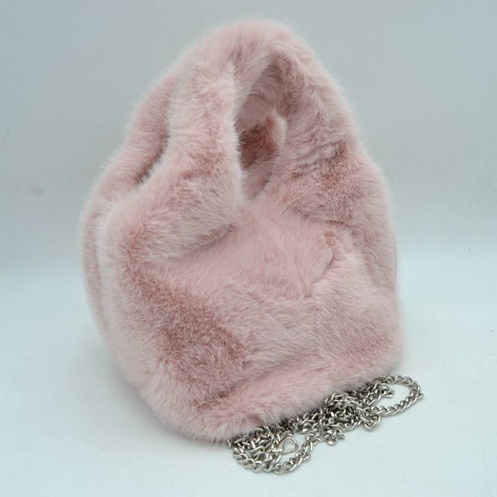 Blush This unique everyday handbag showcases an eye-catching, ultra-soft plush exterior that brings a cozy, tactile texture to your accessory collection. Designed with a structured, rounded silhouette, it includes an integrated top cutout handle woven seamlessly into the form for easy hand carrying, alongside a separate metallic chain strap for versatile alternative styling options. The top opening provides straightforward access to the central main storage compartment