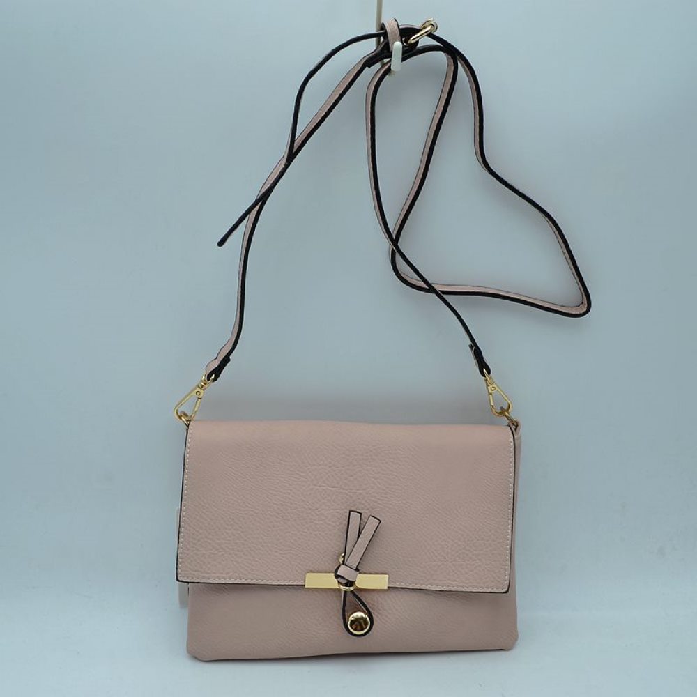 Blush This versatile handbag features a textured finish with a clean foldover flap design, perfect for stylish everyday wear. The front closure is accented with a unique knotted strap detail paired with a polished metallic slider and charm. Designed with a slim profile, it includes a long, adjustable shoulder strap attached via metallic clasps for comfortable hands-free crossbody or shoulder carrying.
