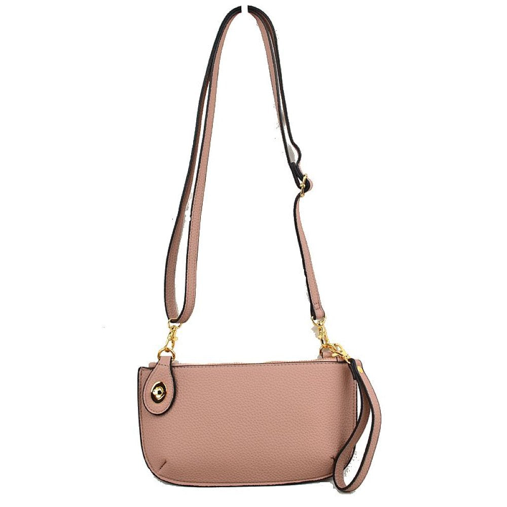 Blush This versatile everyday bag features a compact pebbled textured body with a slightly curved base silhouette. Designed for organized daily or evening use, the main storage compartment is secured by a top zipper closure and accented with a small decorative metallic turn-lock detail on the side panel. It offers multiple carrying options, equipped with a long, adjustable crossbody shoulder strap and a shorter matching wristlet loop