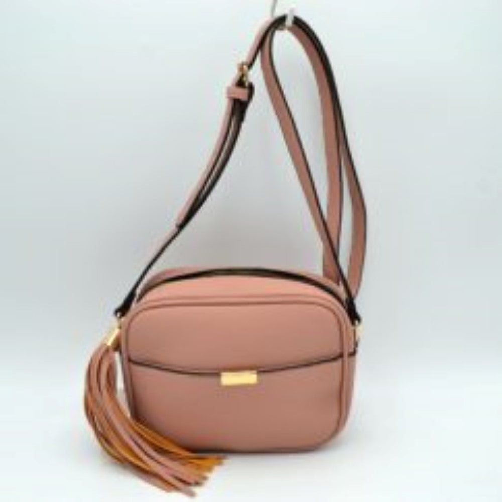 Blush This sophisticated crossbody bag features a structured camera-bag silhouette crafted from a textured pebbled faux leather in a neutral beige tone, making it a versatile addition to any wardrobe. The clean-lined front is detailed with a subtle open slip pocket highlighted by a polished, gold-tone metal hardware accent at the center. Secured by a smooth top-zipper closure, the bag is finished with an adjustable shoulder strap and a dramatic