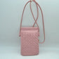 Blush This compact vertical crossbody bag is designed for everyday functionality with a distinct woven textured pattern across its body. It features a slim, continuous cord strap attached securely to the sides with visible knot details for comfortable carrying. A clean horizontal opening at the top allows effortless access to the main storage compartment