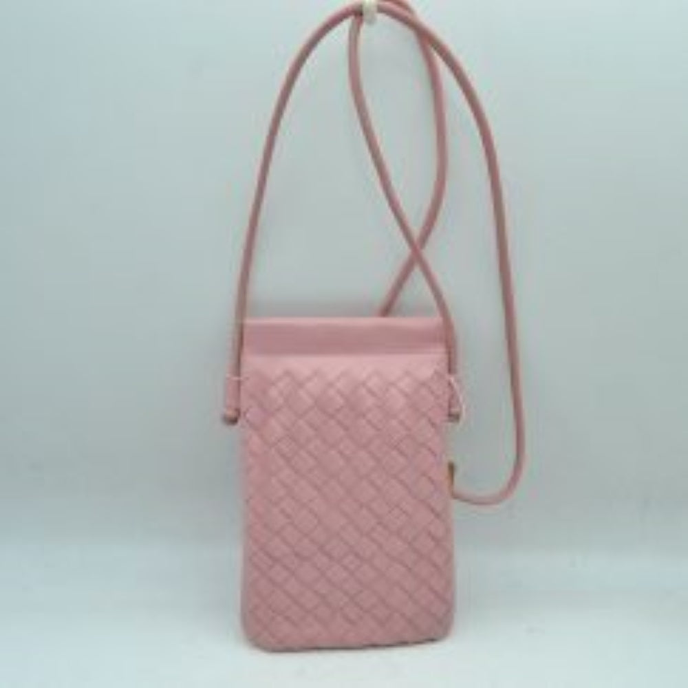 Blush This compact vertical crossbody bag is designed for everyday functionality with a distinct woven textured pattern across its body. It features a slim, continuous cord strap attached securely to the sides with visible knot details for comfortable carrying. A clean horizontal opening at the top allows effortless access to the main storage compartment