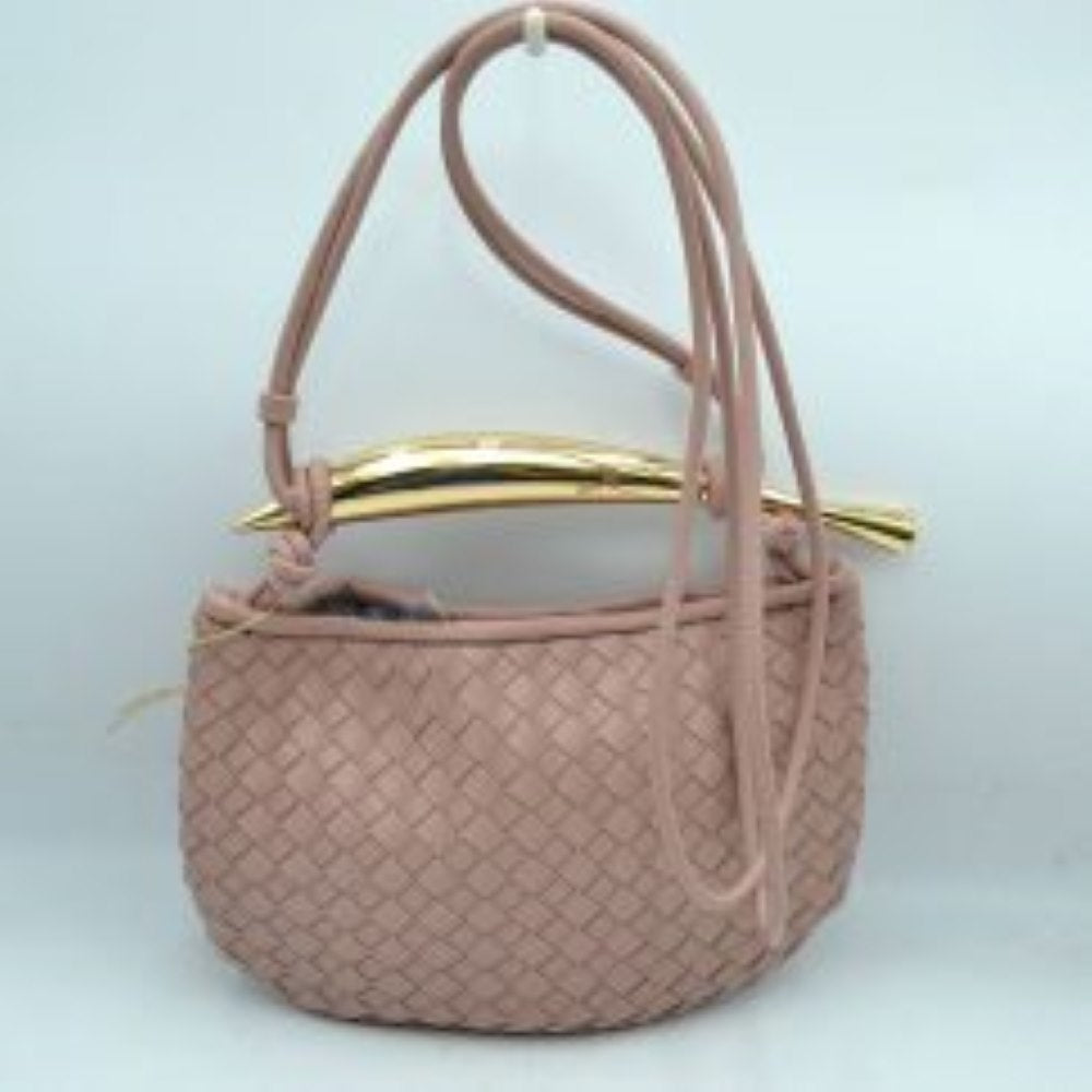 Blush This curved handbag features an intricately textured woven pattern across its exterior body, making it a stylish addition for everyday use. The design is highlighted by a distinctive, polished metallic top handle with tapered ends that anchors the structure. A long, slender matching shoulder strap threads through the top side loops, allowing for easy adjustment and versatile crossbody or shoulder carrying to keep your essentials within reach.