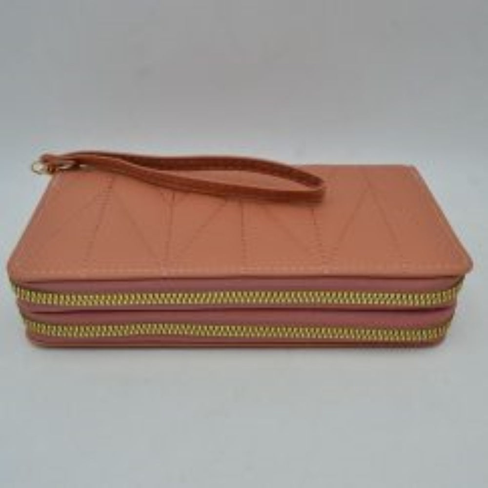 Blush This rectangular long wallet features a distinctive geometric stitched pattern across its exterior, providing a refined and structured look for everyday use. Designed to offer organized storage compartments, it incorporates a dual zip-around closure system with prominent metallic zippers to keep essentials secure. A matching, detachable flat wristlet strap is connected to the side hardware with a metallic clasp, providing an easy and convenient hands-free carrying style.