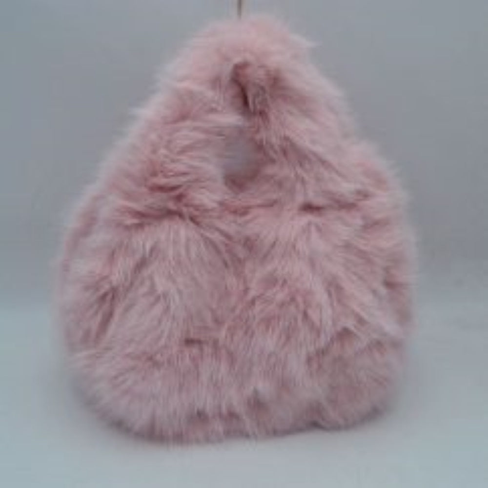 Blush This unique everyday handbag features an eye-catching, ultra-soft shaggy plush exterior that brings a cozy, tactile texture to your accessory collection. Designed with a rounded triangular silhouette, it includes an integrated top cutout handle woven seamlessly into the design for easy hand or wrist carrying. The top opening provides access to a central main storage compartment