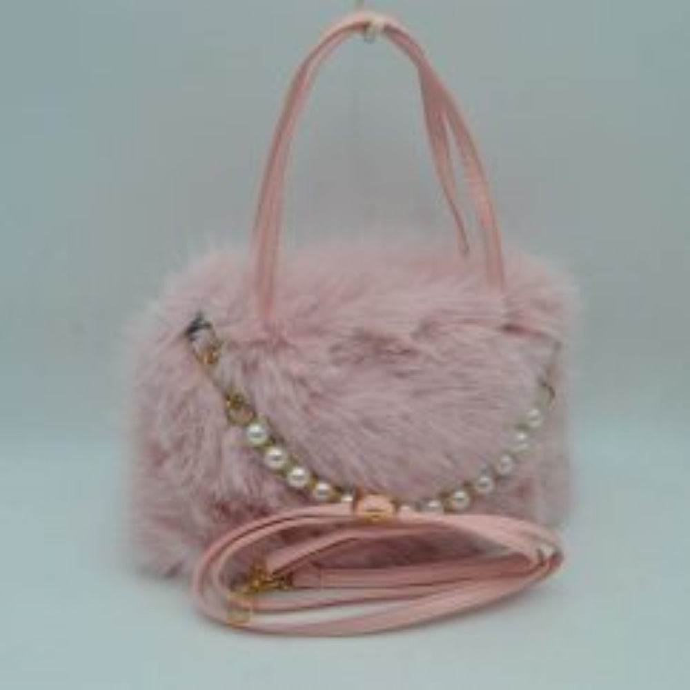 Blush This unique everyday handbag showcases a soft, textured plush exterior that introduces a cozy aesthetic to your accessory collection. The bag features an expansive central storage compartment to accommodate your daily essentials, styled with double top handles for traditional hand carrying. A distinctive strand of large pearl-like beads draped across the front adds a elegant decorative accent