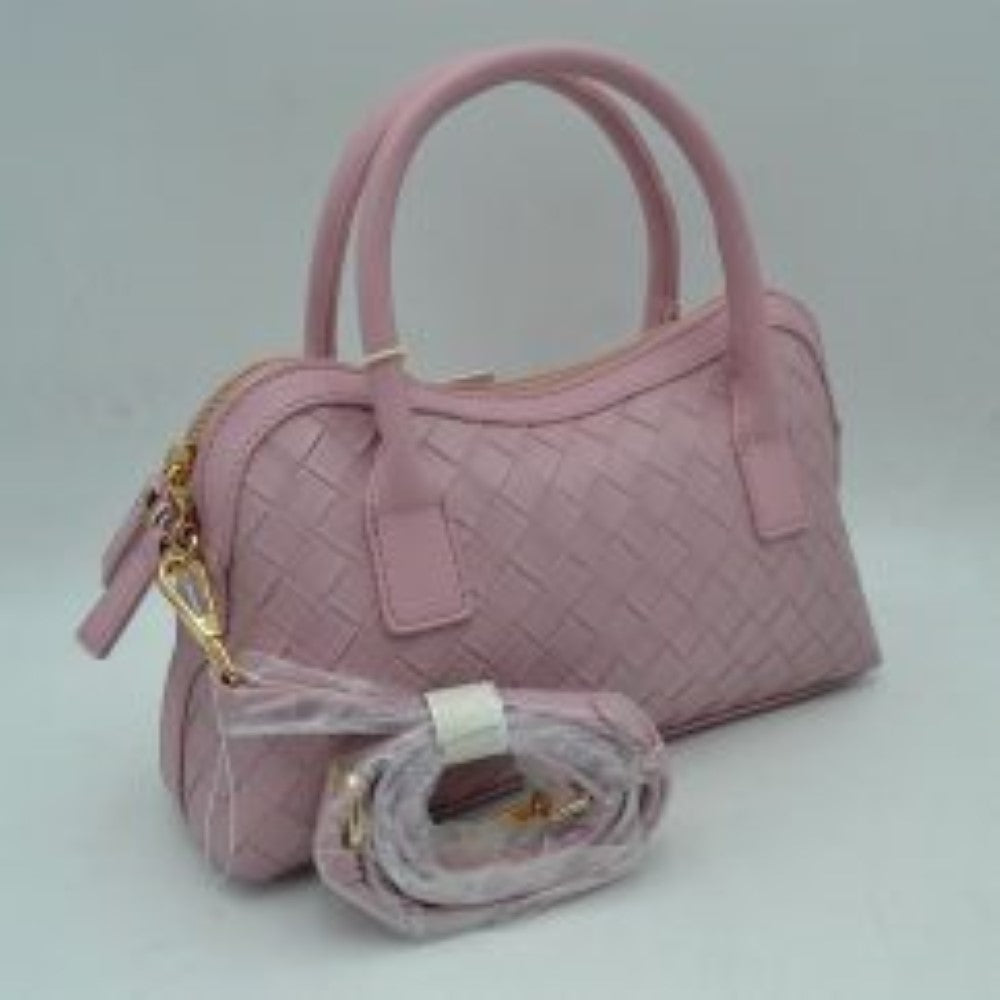 Blush This structured satchel features an intricate woven exterior design with a classic dome silhouette, making it a sophisticated choice for elevated everyday use. It is detailed with sturdy, rounded dual top handles and a decorative hanging leather clochette charm for a touch of timeless style. A gold-tone double-zipper closure secures the main storage compartment, and the bag comes complete with a matching detachable long shoulder strap for versatile crossbody styling options.