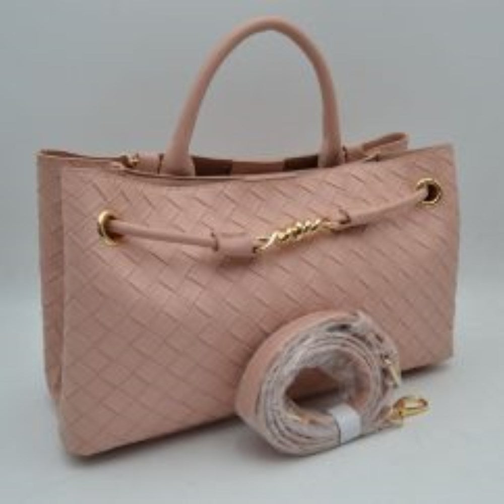 Blush Make a sophisticated statement wherever you go with this elegantly structured woven tote bag. Featuring a distinctive diagonal checkerboard weave pattern, this handbag brings a touch of modern luxury and rich texture to any wardrobe. The front is beautifully accented with a unique metallic centerpiece detail threaded through polished grommets, adding a contemporary twist to a classic silhouette. Designed for maximum versatility, it features comfortable dual top handles alongside a wrapped