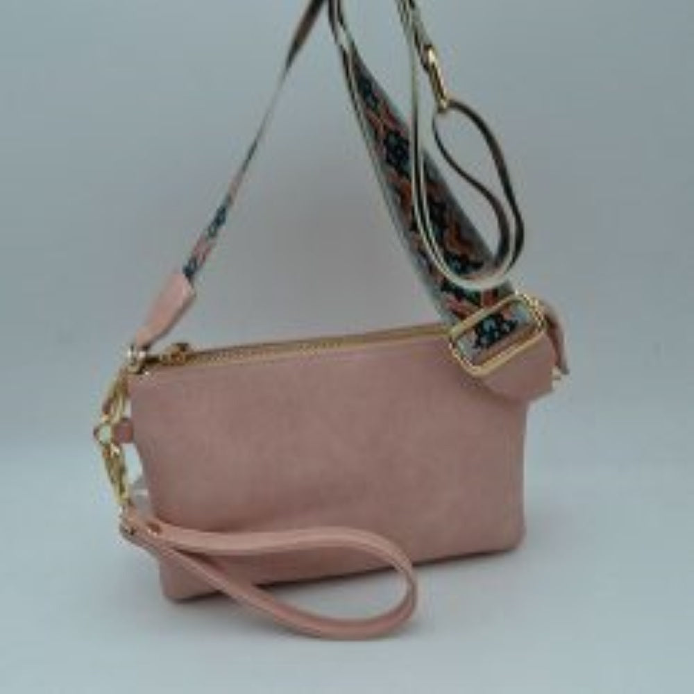 Bush This versatile clutch is designed for seamless everyday transition and features multiple carrying options to suit your style. It is equipped with secure top zipper compartments to keep your daily essentials safely organized and within reach. For carrying flexibility, the bag comes with both a matching wristlet loop and a wide, adjustable shoulder strap decorated with a detailed geometric woven pattern, both attaching easily via sturdy metallic clasps.