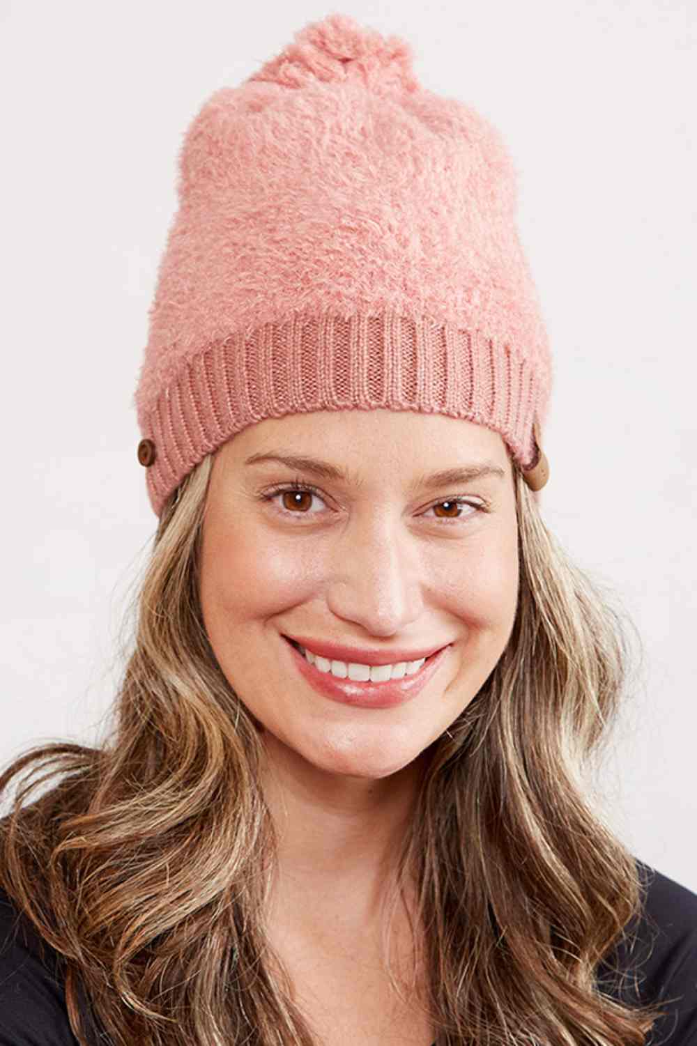 Blush Wrap yourself in warmth with this soft acrylic beanie featuring a ribbed brim, decorative buttons, and a playful pom pom top. Perfect for chilly days, the 100% acrylic construction keeps you cozy without the bulk. A timeless accessory that works with any winter wardrobe.