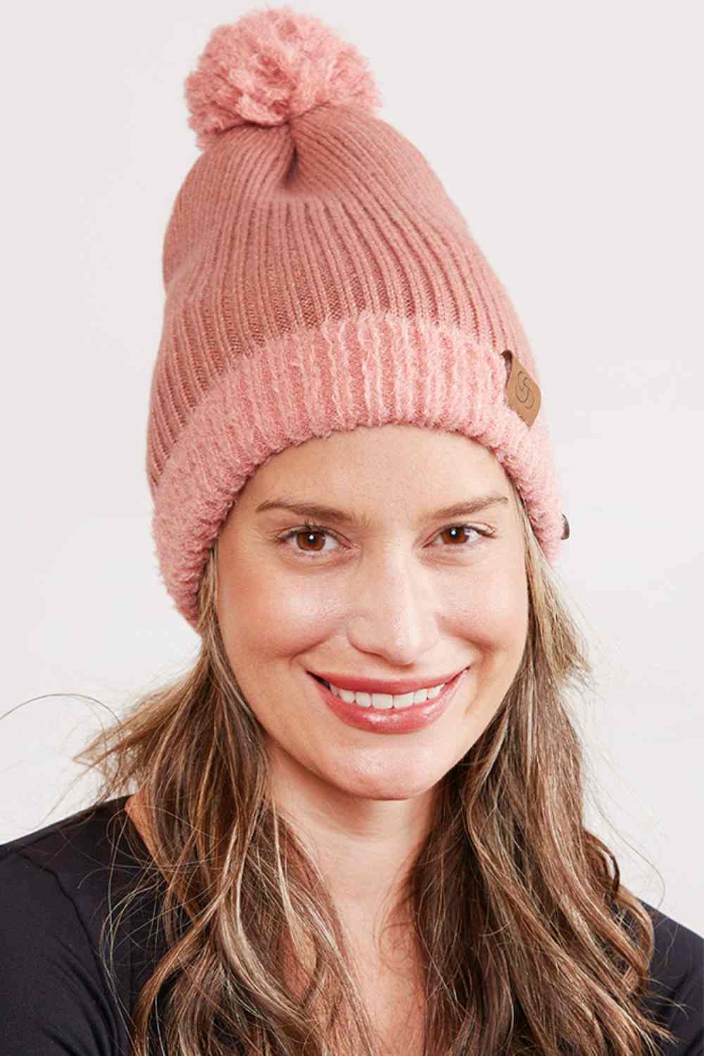 Blush Cozy up this season with our Ribbed Brim Button Pom Beanie, designed for warmth and style. Crafted from 100% acrylic, this soft knit hat features a classic ribbed texture, decorative buttons, and a charming pom pom on top.