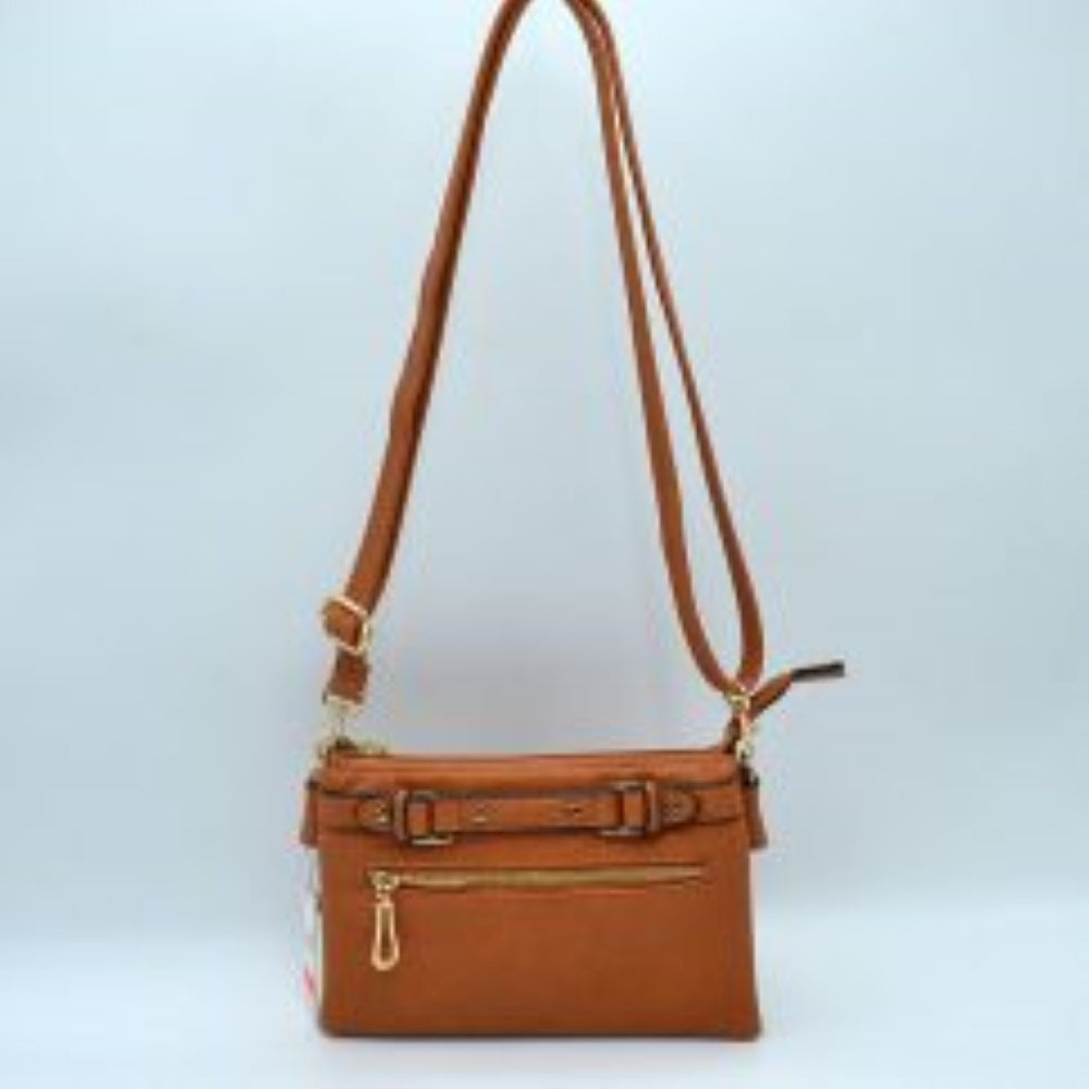 Brown This functional crossbody bag is designed for organized everyday use, featuring a textured exterior equipped with multiple secure storage compartments. The front panel includes a convenient horizontal zippered pocket accented with an oversized metallic zipper pull, situated beneath a decorative horizontal band detailed with metallic studs and loops.