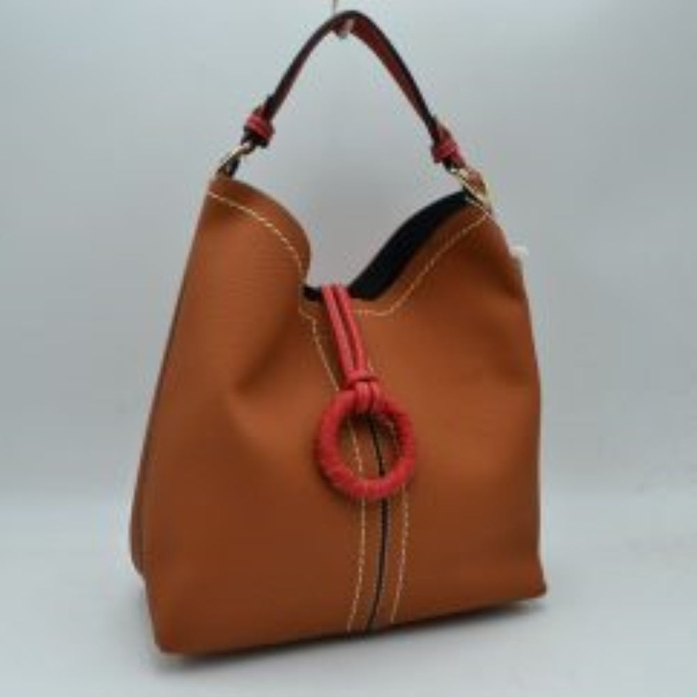Brown This structured everyday bucket bag features a pebbled textured body with a distinctive curved, dip-top opening and prominent contrast stitching details along the front panel. It is designed with a singular flat top handle anchored to the sides by polished metal hardware loops for comfortable carrying. A central loop strap extends from the back to the front