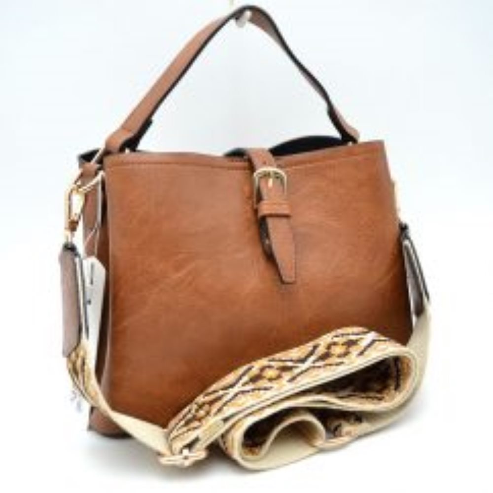 Brown Designed for stylish everyday use, this versatile bag features a textured finish with a central decorative buckle strap across the open top. It offers multiple carrying options, including a sturdy top handle and a wide, removable shoulder strap showcasing a detailed geometric woven pattern. Complete w/ secure metal hardware clasps and an adjustable slide buckle on the patterned strap, this spacious bag blends practical storage compartments w/ a modern aesthetic for convenient hands-free styling.