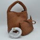 Brown This stylish everyday hobo bag features an all-over classic basket weave design and a slouchy silhouette. It is crafted with a seamless, integrated wide top handle that transitions directly into the main storage compartment for comfortable hand or shoulder carrying.