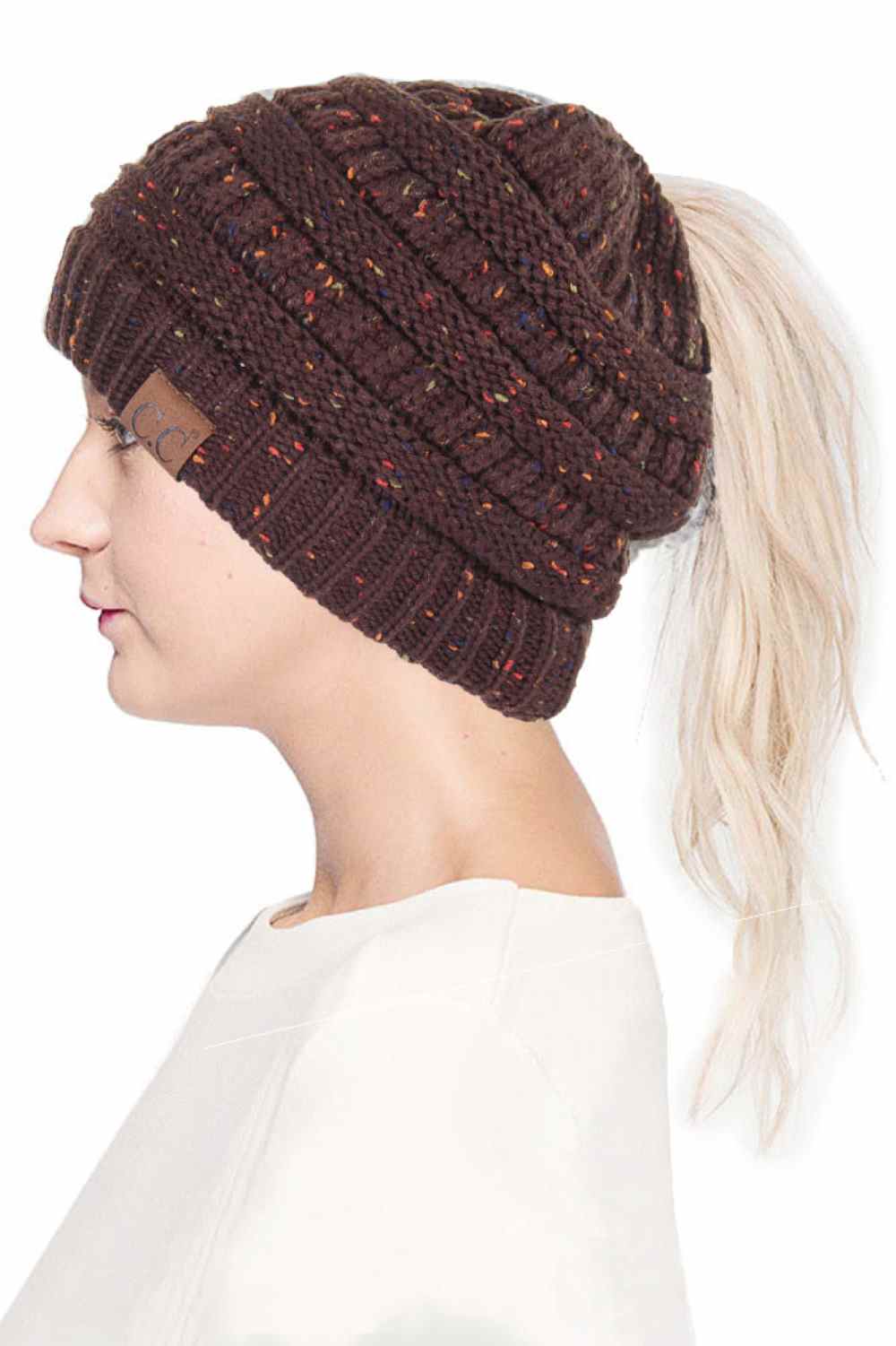 Brown The C.C Confetti Ponytail Messy Bun Beanie features a soft knit design with subtle confetti flecks for a fun, playful look. Designed with a convenient opening for ponytails or messy buns, it keeps you warm while allowing you to style your hair comfortably.