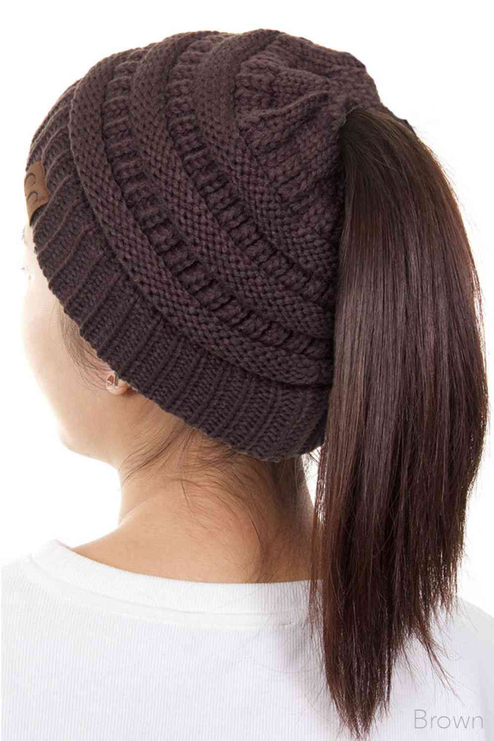 Brown The C.C Solid Color Ponytail Messy Bun Beanie combines comfort with versatility for effortless everyday style. Crafted from 100% soft acrylic, this beanie features an open crown design that accommodates ponytails and messy buns while keeping you warm. The one-size-fits-most construction ensures a secure, flattering fit for virtually anyone. Perfect for casual outings, workouts, or relaxed weekends, this practical accessory transitions seamlessly from season to season.