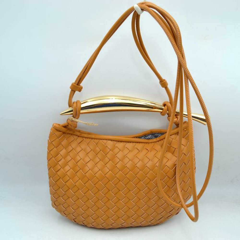 Brown This curved handbag features an intricately textured woven pattern across its exterior body, making it a stylish addition for everyday use. The design is highlighted by a distinctive, polished metallic top handle with tapered ends that anchors the structure. A long, slender matching shoulder strap threads through the top side loops, allowing for easy adjustment and versatile crossbody or shoulder carrying to keep your essentials within reach.