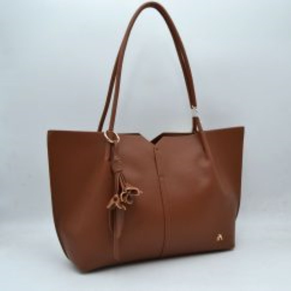 Brown Bring a clean, contemporary aesthetic to your daily wardrobe with this sophisticated tote bag. Featuring a distinctive geometric cutout design along the upper trim, this shoulder bag offers a modern architectural edge while remaining perfectly functional. The smooth, textured exterior is detailed with subtle vertical center stitching and a small, polished metallic logo accent on the lower corner. Designed for comfort and convenience