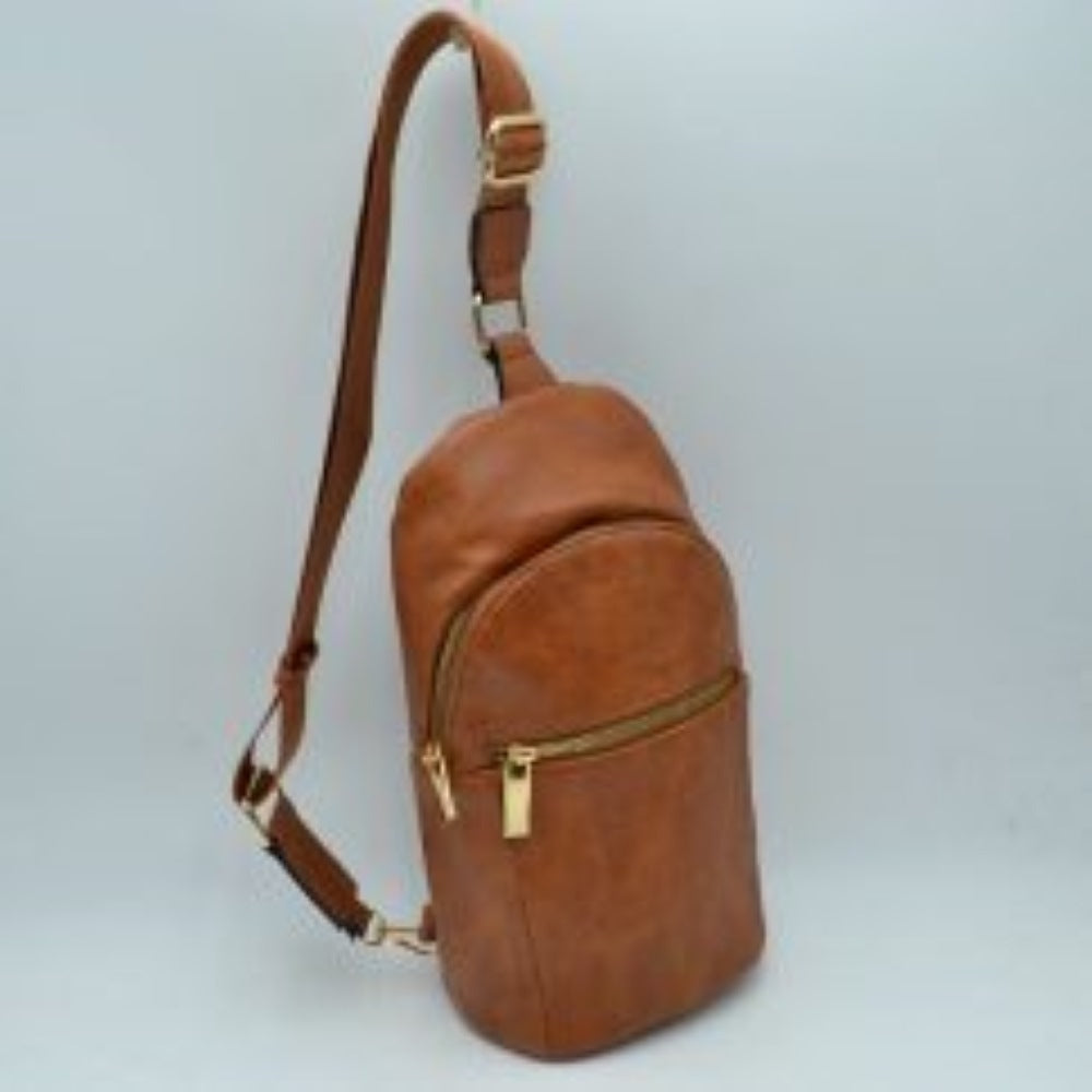 Brown This practical sling bag features a textured, grained finish exterior engineered for active everyday use. It provides multiple tiered storage compartments, including a curved main zippered section and a smaller, secondary horizontal zippered front pocket to keep essentials organized. The bag is designed with a single wide shoulder strap style that connects through a square metallic loop and includes an integrated adjustment buckle to alter the carrying length easily.
