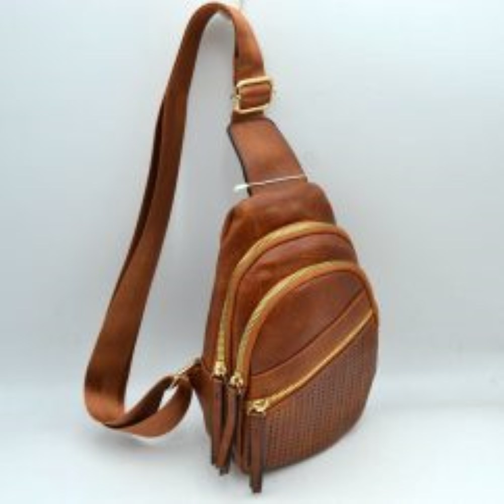 Brown This functional sling bag features a textured, grained finish with a multi-tiered silhouette engineered for organized everyday use. It provides multiple distinct storage compartments, including a primary curved main section, an intermediate arched pouch, and a lower pocket featuring a horizontal zipper closure and a decorative perforated design. The bag is completed by a single wide.