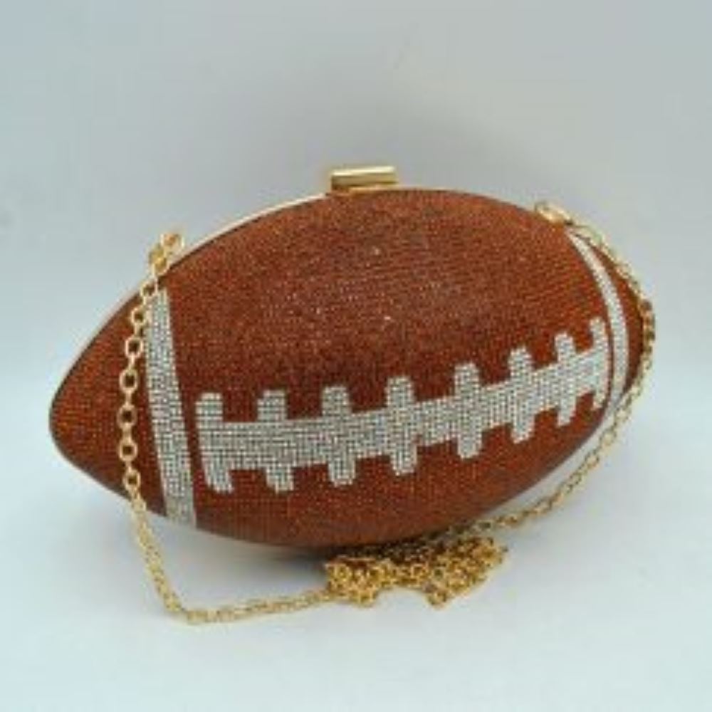 Brown This unique evening clutch bag is designed in a distinct football silhouette completely covered in shimmering rhinestones, making it an eye-catching statement piece. The textured exterior features contrasting silver rhinestone detailing that mimics classic football lacing, set against a rich bronze background. Equipped with a secure metallic top-clasp closure to keep your essentials safe