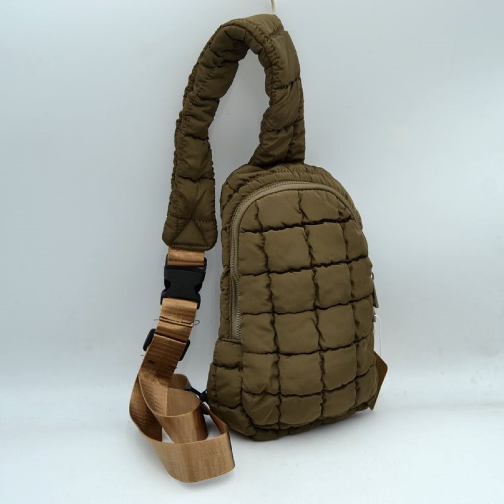 Brown Stay effortlessly hands-free with the ultra-trendy sling bag. Combining an ergonomic, close-to-body fit with the highly sought-after puffer aesthetic, this compact pack is the ultimate accessory for city commuting, travel, hiking, or casual day trips.