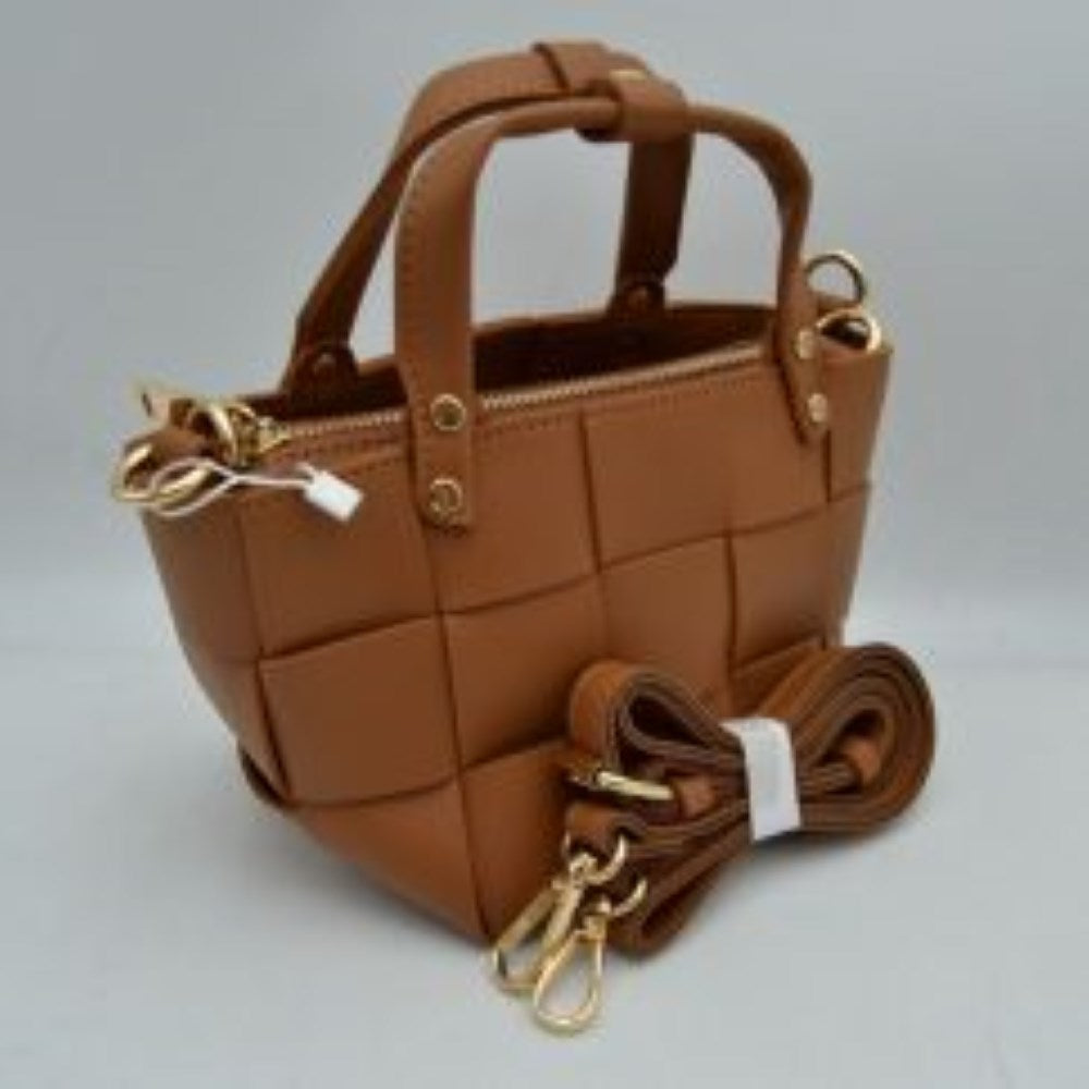 Brown Infuse a touch of modern luxury into your accessory collection with this striking square mini tote bag. Defined by an oversized, wide-interlocking basket weave design, this bag delivers a clean, architectural aesthetic with plenty of dimensional texture. It features sturdy dual top handles secured by polished metallic rivets, alongside a full top-zipper closure to keep your belongings tucked safely away. For seamless, on-the-go versatility