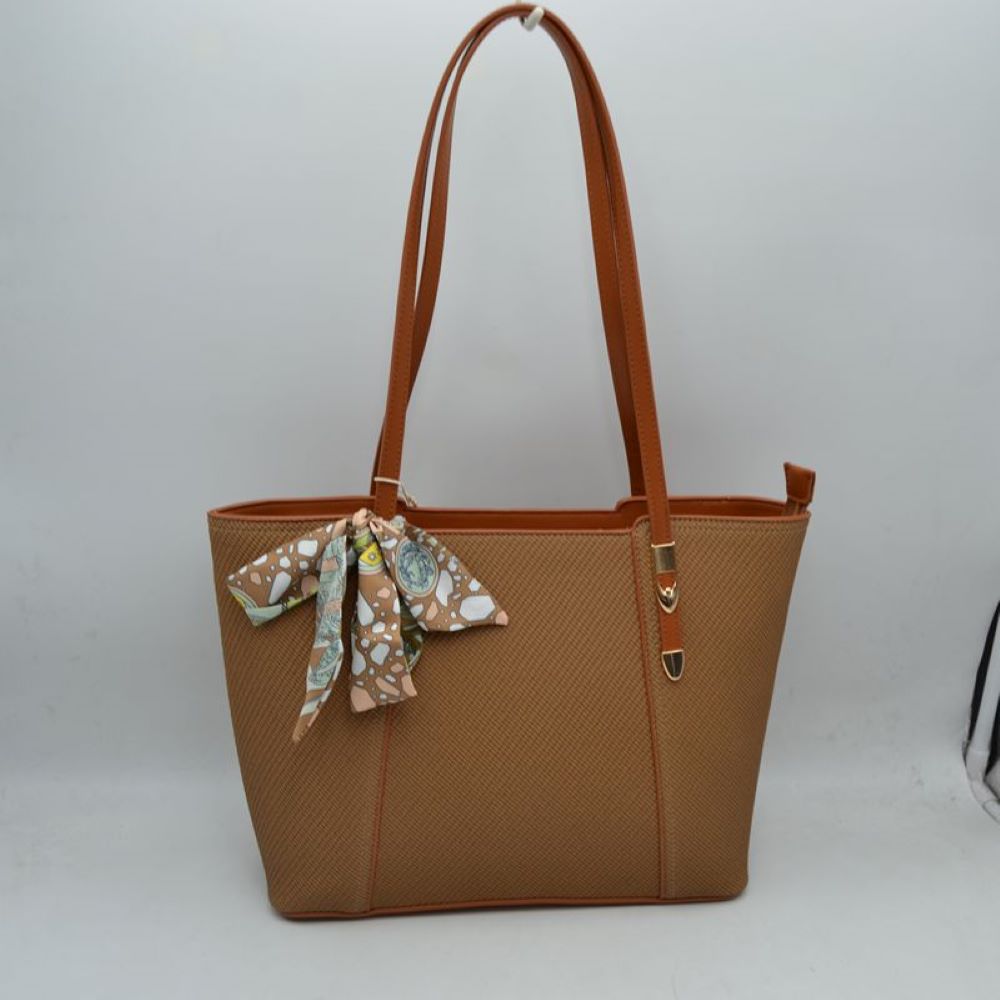 Brown Bring a touch of effortless resort-chic into your daily routine with this stunning cream and cognac shoulder tote. Designed with an elegant chevron-textured weave and beautifully contrasted by rich, warm tan accents, this bag is the ultimate fusion of classic sophistication and everyday practicality. Perfect for office styling, weekend getaways, or casual city strolls, it arrives detailed with a colorful, artistic silk-style scarf playfully tied to the handle for an immediate touch of luxury.