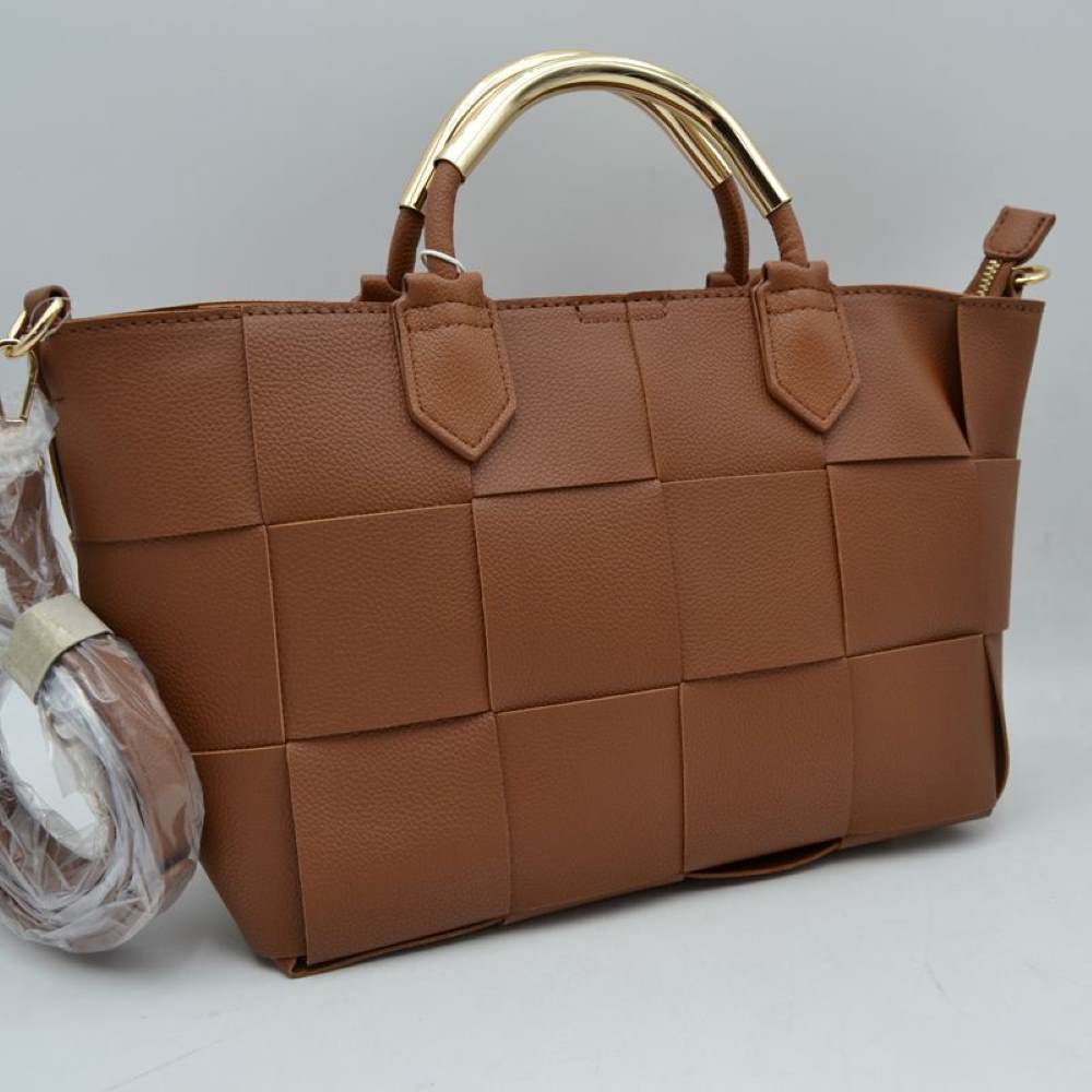 Brown Make a sophisticated statement with this beautifully designed satchel handbag. The exterior showcases an eye-catching, extra-wide basket-weave pattern that adds modern texture and dimensional depth to a classic silhouette. Setting this piece apart is the sleek, polished metallic accent arched over the top carry handles, bringing an upscale, architectural touch to your look. Equipped with soft, flexible side panels